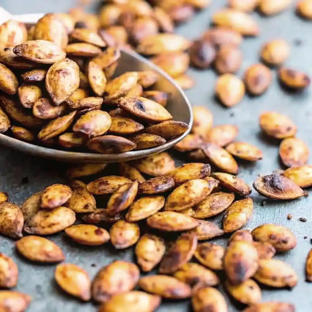 Pumpkin Seed Recipe That Delivers Bold Crunch Fast Pumpkin Seed Recipe Close-up of crispy roasted pumpkin seeds with deep golden color on a spoon