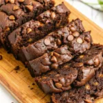 Chocolate Zucchini Bread That’s Moist, Fudgy, and Totally Addictive Chocolate Zucchini Bread Moist Chocolate Zucchini Bread sliced and topped with chocolate chips on a wooden board