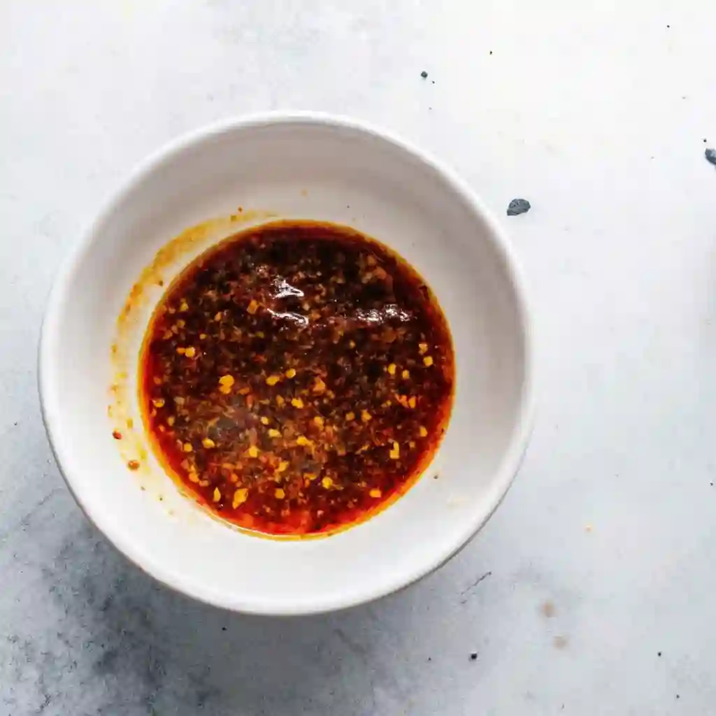 Air Fryer Chicken Breast : The Last Juicy Recipe You’ll Ever Need Air Fryer Chicken Breast Bowl filled with mixed oil and spices forming a paste for seasoning chicken