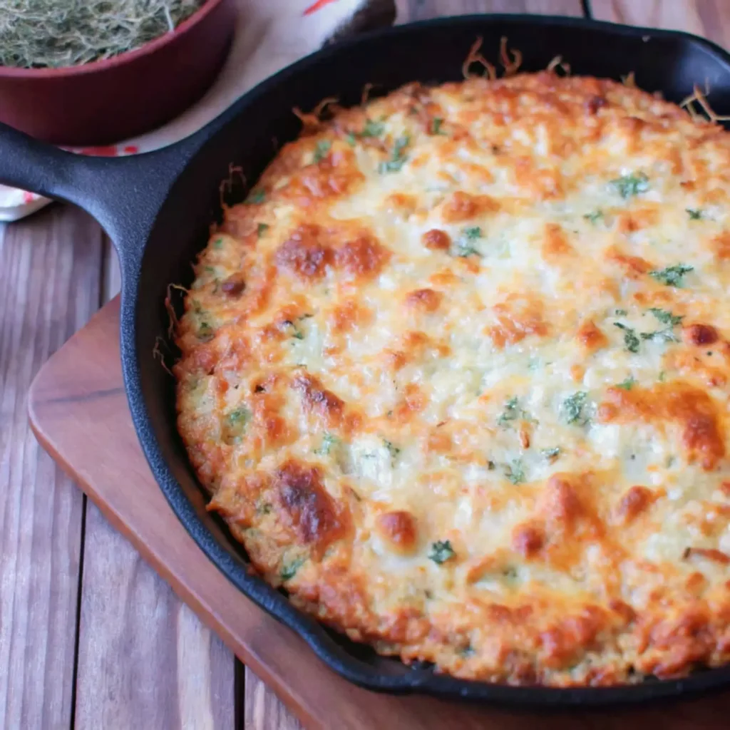 Marry Me Chicken Dip Recipe marry me chicken dip A hot skillet of baked Marry Me Chicken Dip, with a bubbly, golden-brown cheese crust and flecks of fresh herbs.