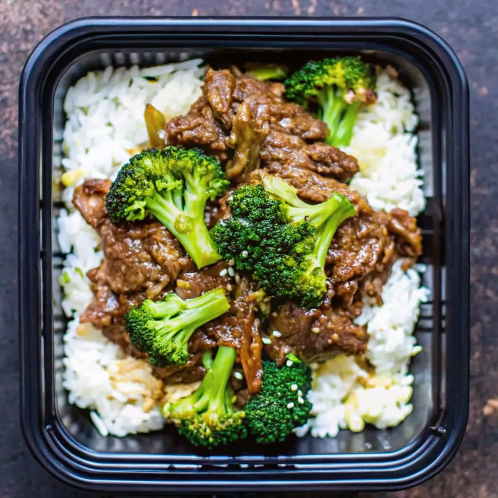 How to Cook Beef and Broccoli Chinese Style That Beats Takeout how to cook beef and broccoli chinese Beef and broccoli stir-fry served over white rice in a black meal prep container