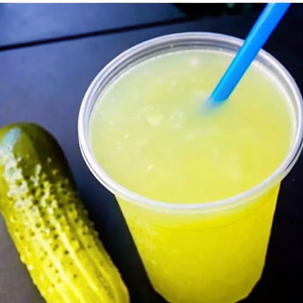 Lemonade and Pickle Juice: Weird or Wonderful? Lemonade and Pickle Juice Popeyes Fried Pickle Lemonade with a whole pickle beside the cup