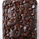 Close-up of moist double chocolate zucchini bread topped with melted chocolate chips