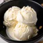Pinon ice cream Recipe pinon ice cream Three scoops of creamy homemade pinon ice cream in a black bowl.
