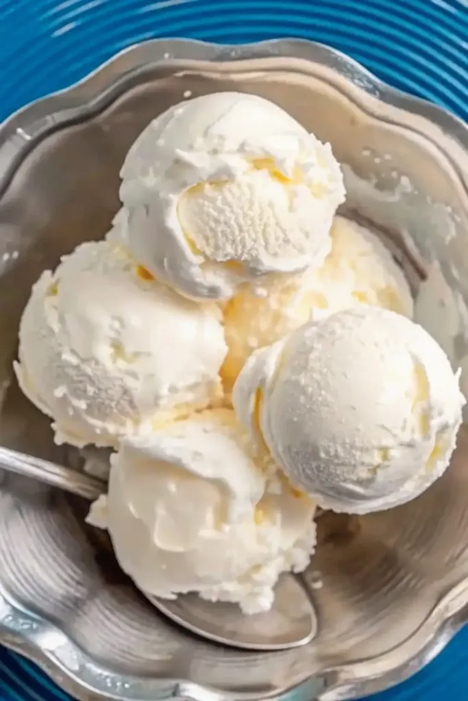 Pinon ice cream Recipe pinon ice cream Several scoops of creamy pinon ice cream in a silver bowl with a spoon.
