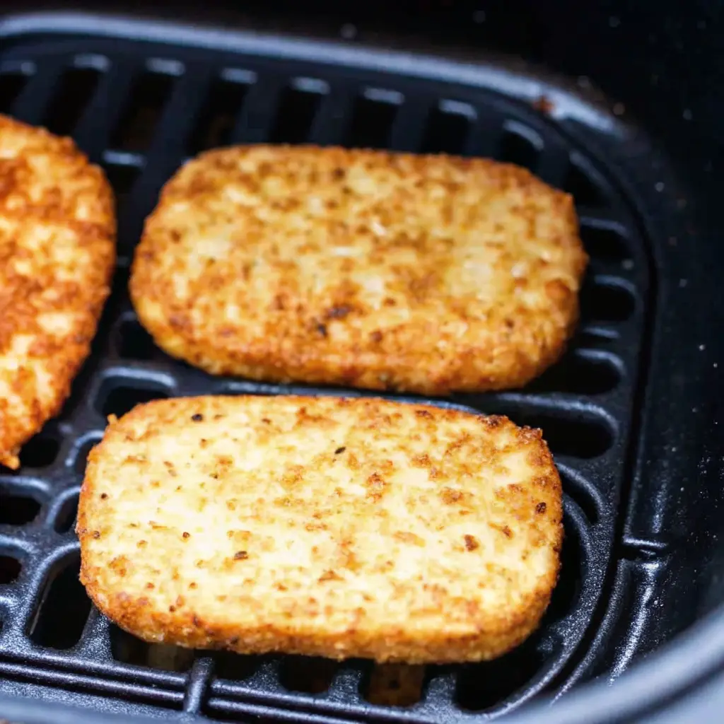 Trader Joes Hashbrown Air Fryer : Instructions trader joes hashbrown air fryer Close-up of crispy, goldentrader joes hashbrown air fryer patties cooking in a single layer inside a black air fryer basket.