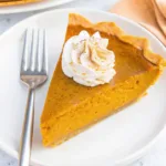 Pumpkin Pie with Sweetened Condensed Milk: The Creamiest Twist You’ll Try Pumpkin Pie with Sweetened Condensed Milk Served slice of pumpkin pie with sweetened condensed milk topped with whipped cream on a white plate