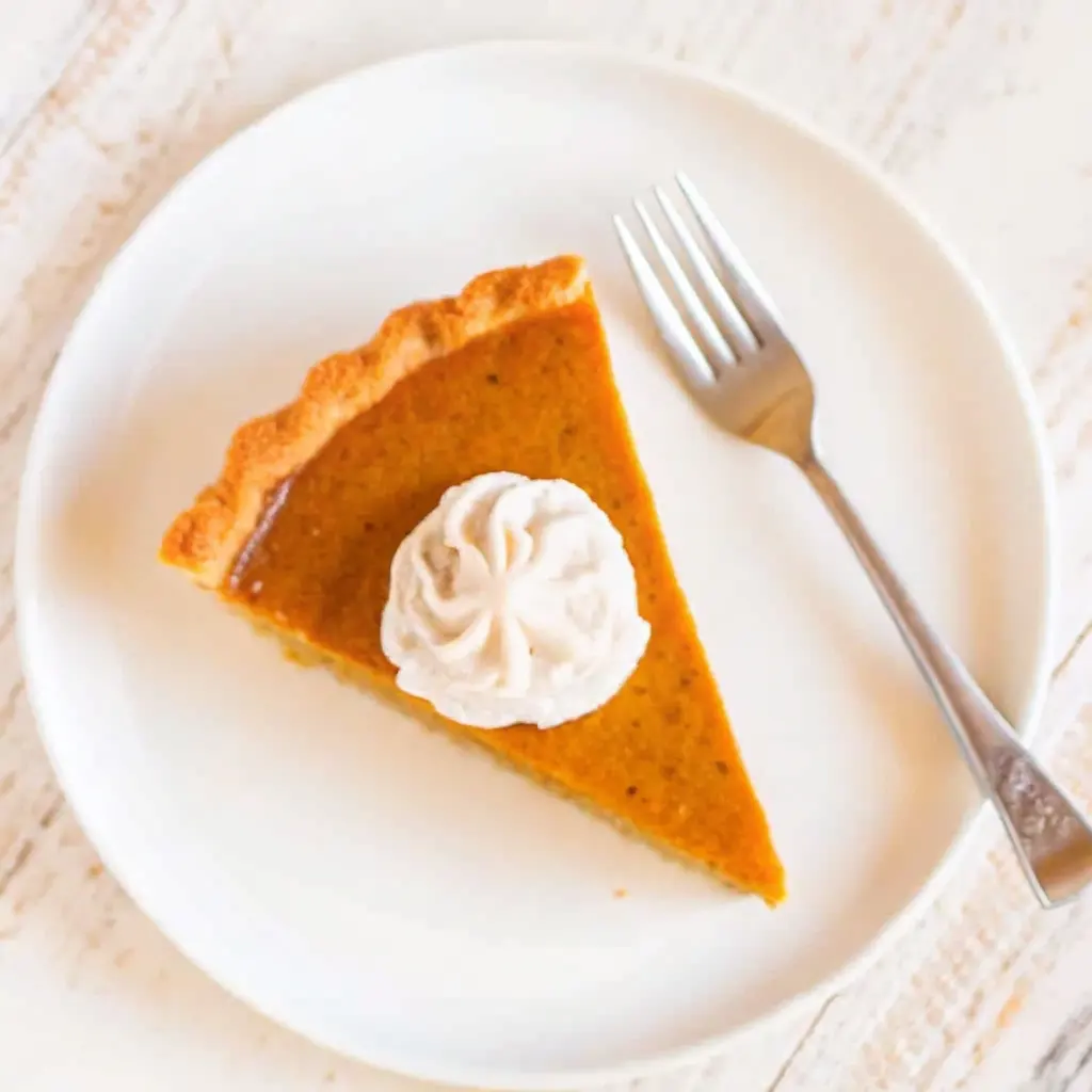 Pumpkin Pie with Sweetened Condensed Milk: The Creamiest Twist You’ll Try Pumpkin Pie with Sweetened Condensed Milk Top view of pumpkin pie slice with sweetened condensed milk and whipped cream on a white plate