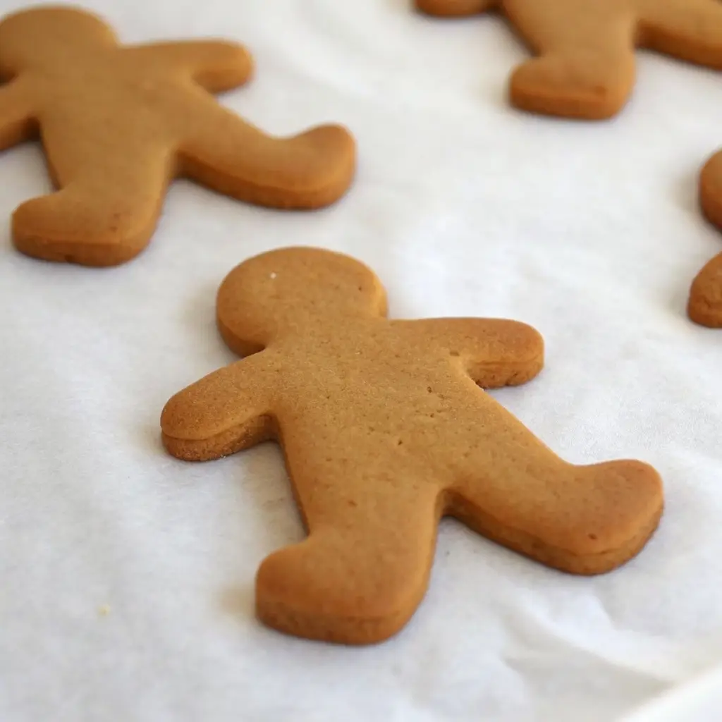 Gingerbread Cookies: Soft, Spiced, and Perfect for Decorating gingerbread cookies Close-up of a freshly baked gingerbread man cookie on parchment paper