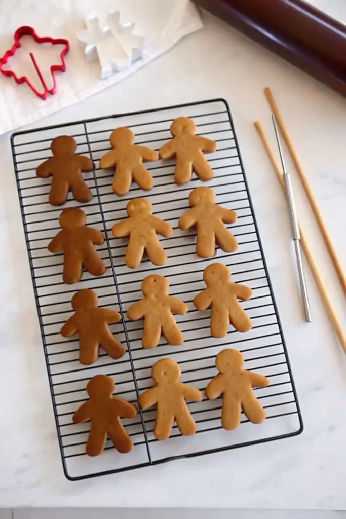 Gingerbread Cookies: Soft, Spiced, and Perfect for Decorating gingerbread cookies Gingerbread man cookies cooling on a wire rack with cookie cutters and rolling pin nearby