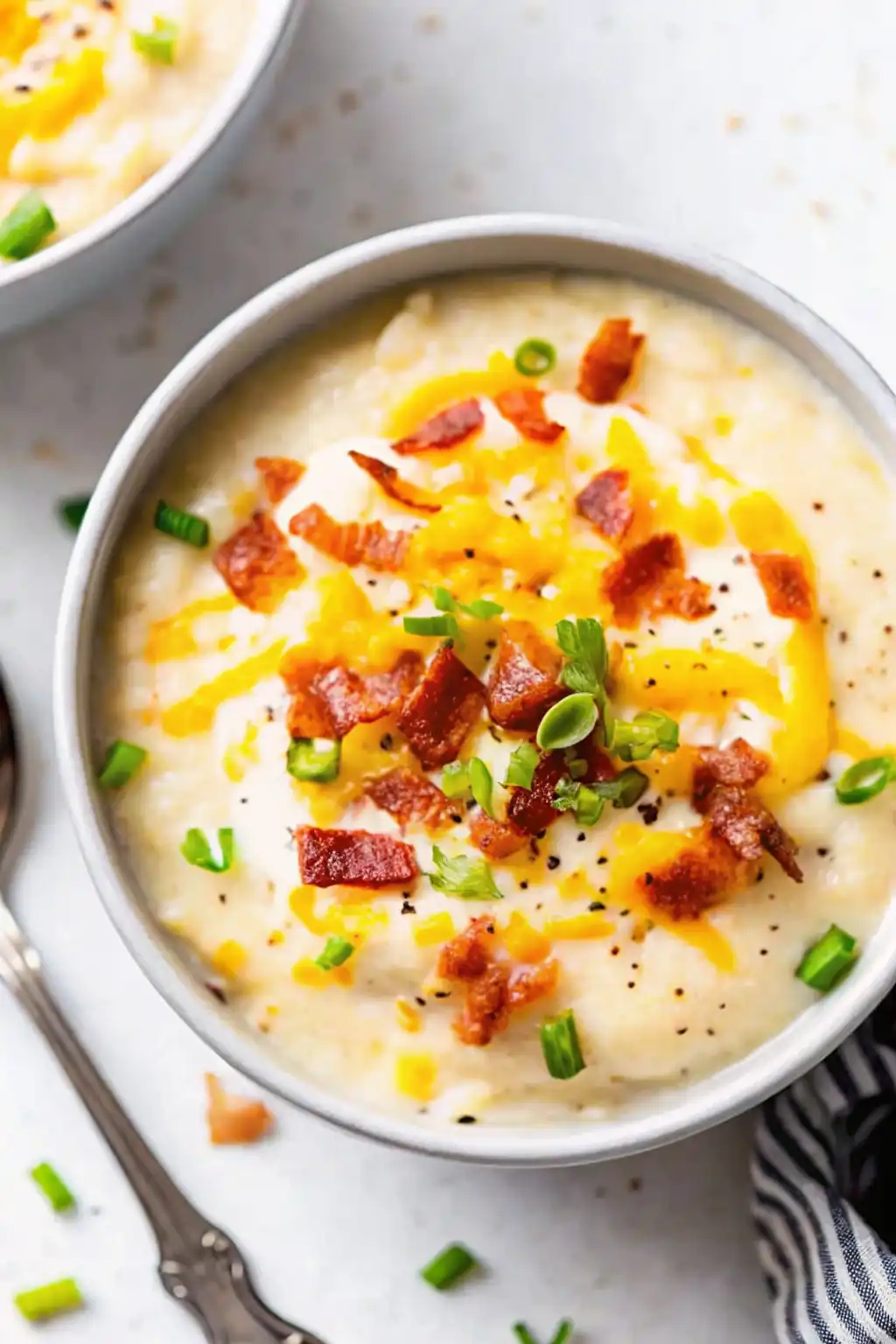 Loaded Potato Soup Recipe: Creamy, Cheesy Comfort Food loaded potato soup Creamy loaded potato soup topped with crispy bacon, melted cheddar cheese, sour cream, and fresh green onions in a bowl.