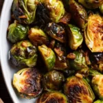 Honey Balsamic Brussels Sprouts That Taste Like Fall in Every Bite Honey Balsamic Brussels Sprouts Roasted honey balsamic brussels sprouts on white serving dish