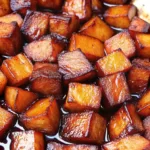 Close-up of honey roasted sweet potatoes with caramelized glaze