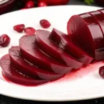 Jellied Cranberry Sauce: Classic, Simple, and Irresistibly Smooth Jellied Cranberry Sauce Sliced jellied cranberry sauce on a white serving plate