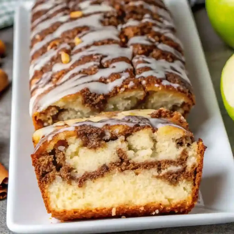 Amish Apple Fritter Bread Recipe for Fall Sweet Breads cheesecake Freshly baked Amish Apple Fritter Bread topped with glaze and cinnamon swirl.