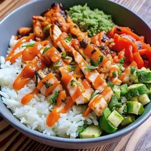 Delicious Bang Bang chicken rice bowl topped with fresh vegetables and creamy dressing