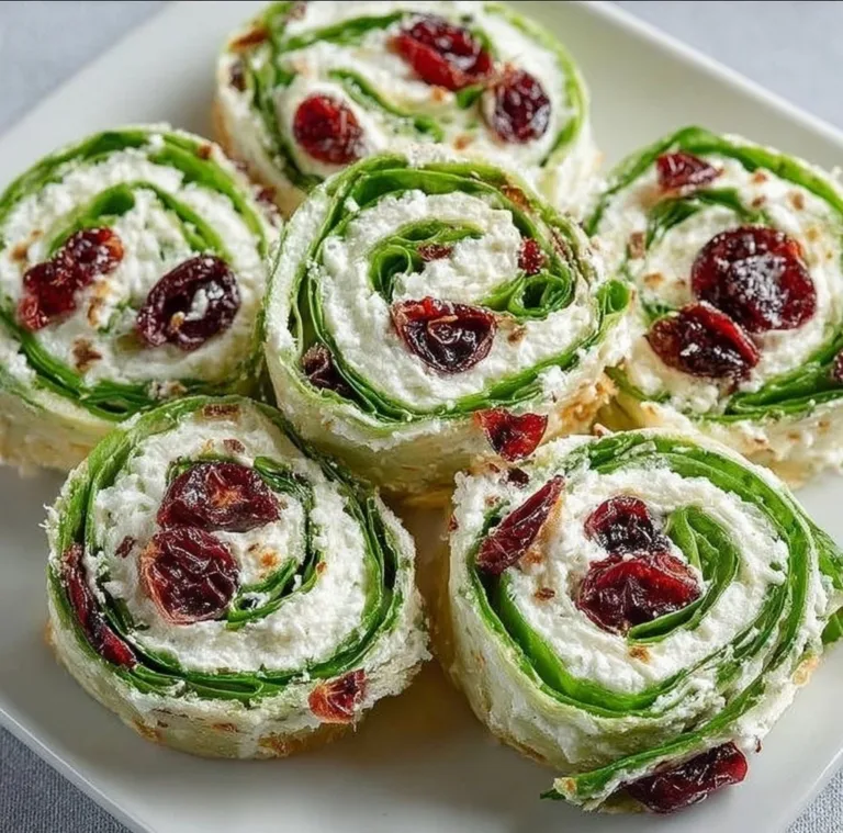 Christmas Cranberry Pinwheels Pumpkin Shaped Cinnamon Rolls with Cream Cheese Frosting Festive Christmas Cranberry Pinwheels on a holiday serving platter