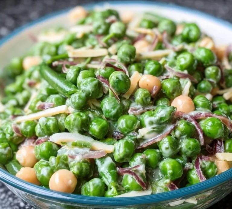Freshly prepared easy English pea salad with vibrant greens and dressing