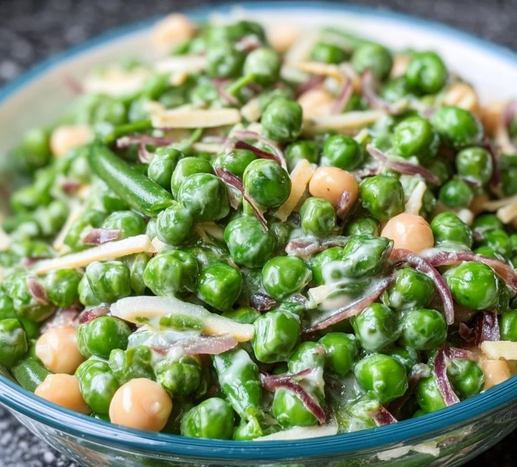 Freshly prepared easy English pea salad with vibrant greens and dressing