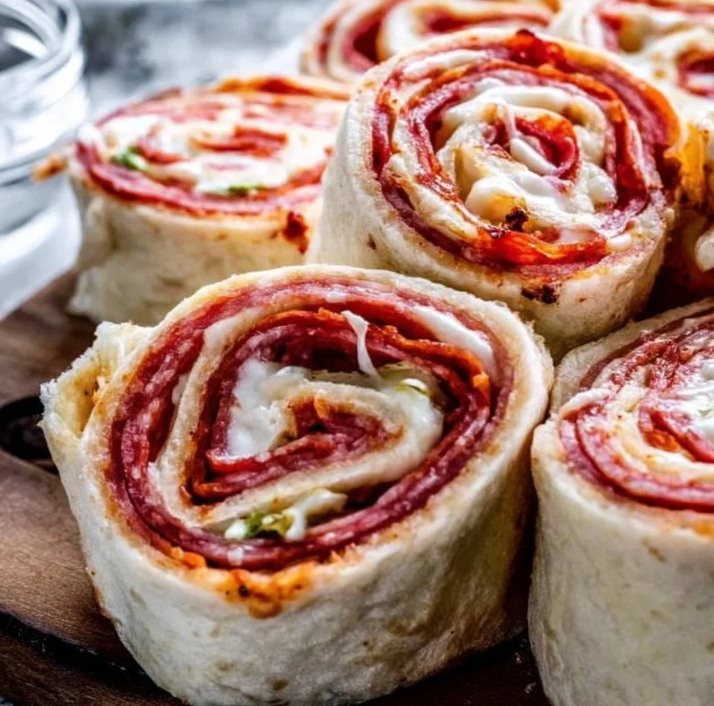 Plate of homemade pepperoni pinwheels with herbs and cheese