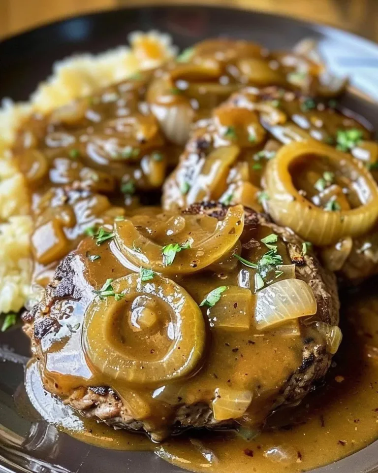 Delicious hamburger steak with onions and gravy served on a plate