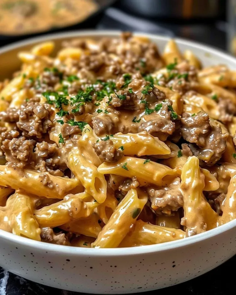 Creamy beef pasta dish topped with herbs and spices for a high-protein meal