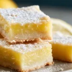 Freshly baked Pioneer Woman lemon bars on a white plate